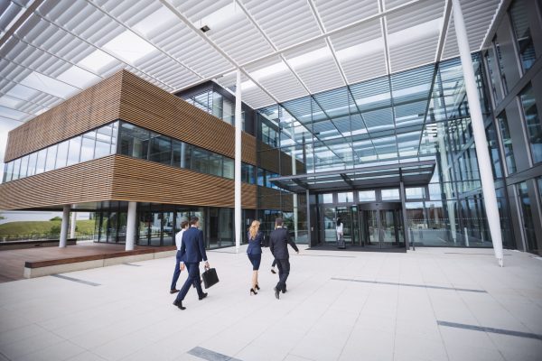 Group of business people entering into an office building